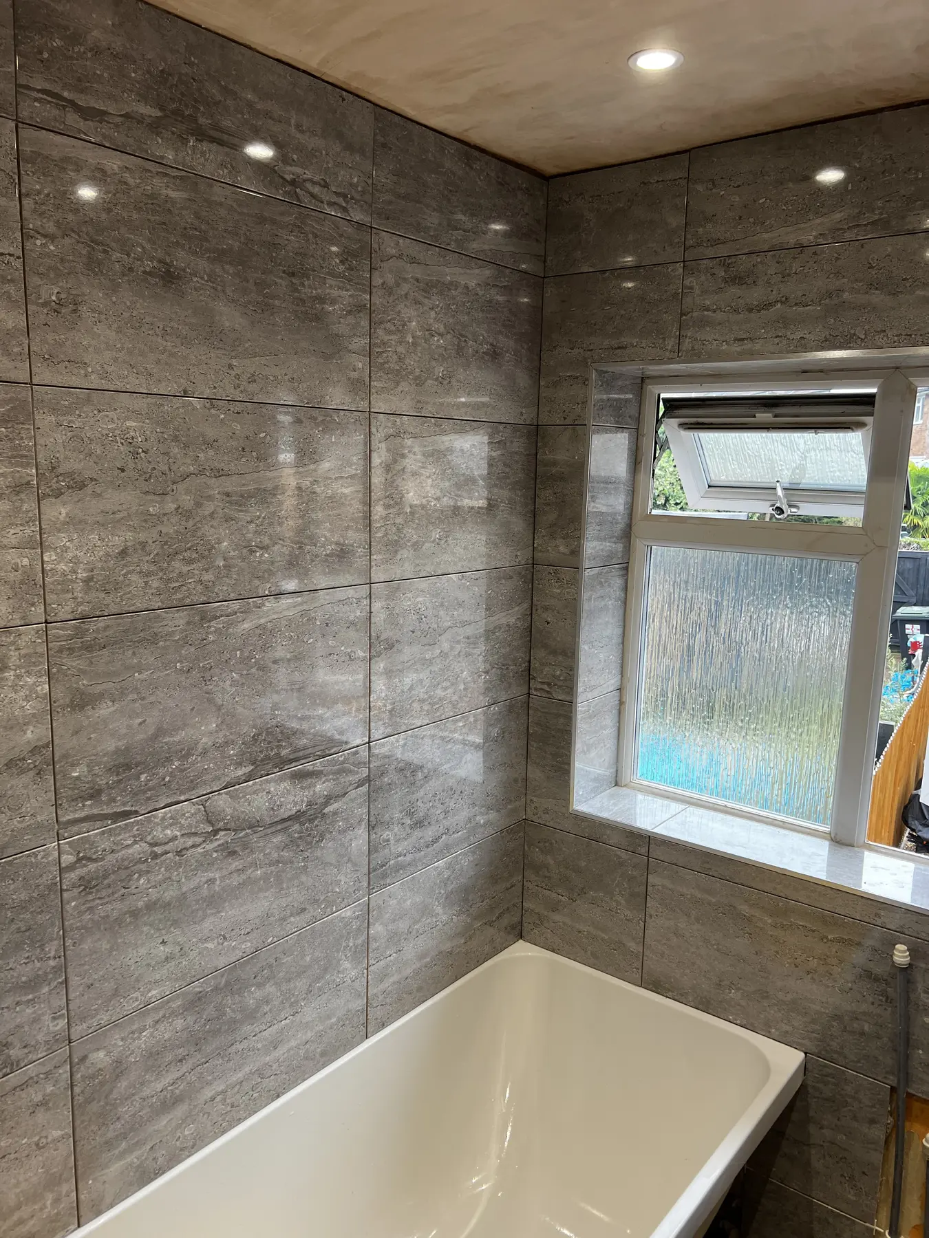 Bathroom grey tiling during installation