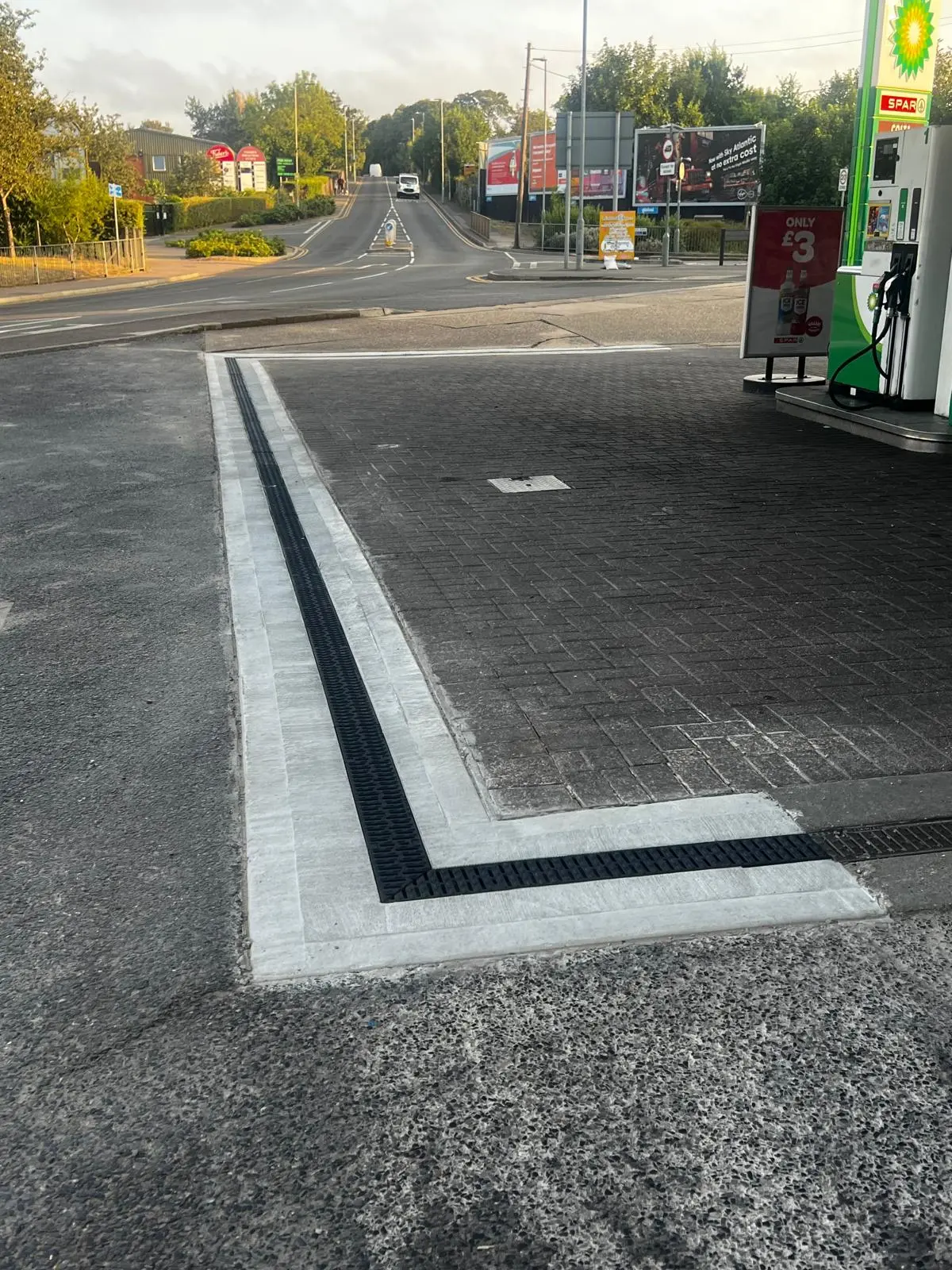 Completed channel drainage around a commercial petrol-station forecourt