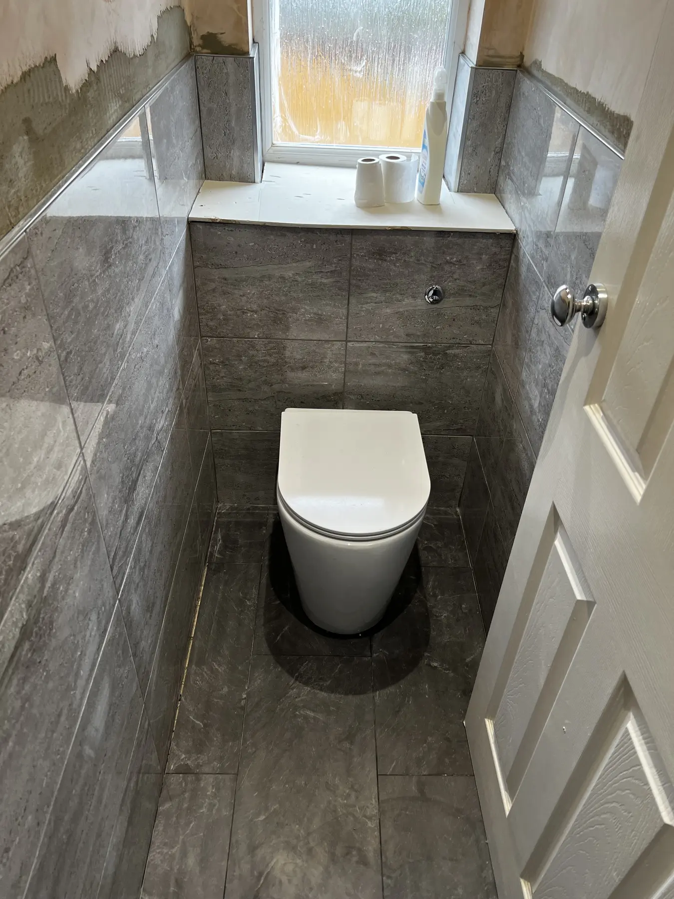 Completed grey bathroom installation by T&T Contractors in Watford