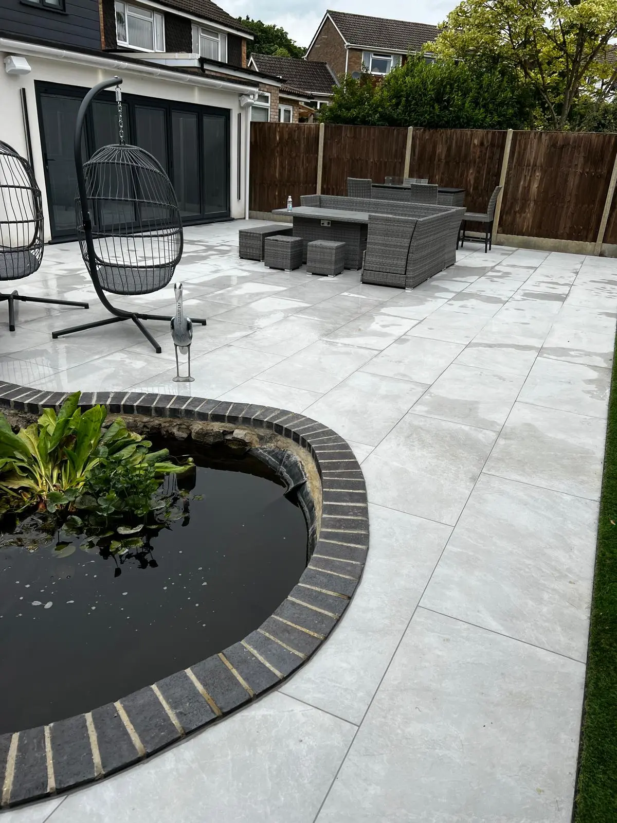 Landscaped garden with pond and patio completed by T and T Contractors